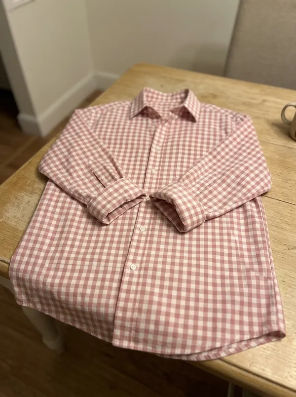 gingham shirt photographed flat on a table, phone quality
