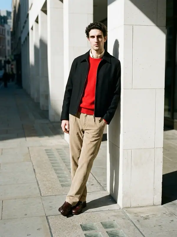 black wool zip harrington + scarlet crewneck worn by an AI male model, editorial shoot