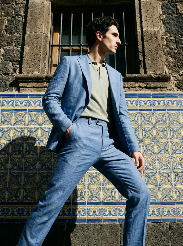 cobalt blue linen suit + sage knitted polo worn by an AI male model, editorial shoot