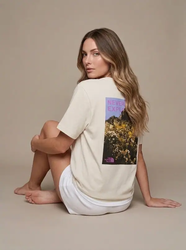 never stop exploring back-graphic tee worn by an AI model, studio shoot