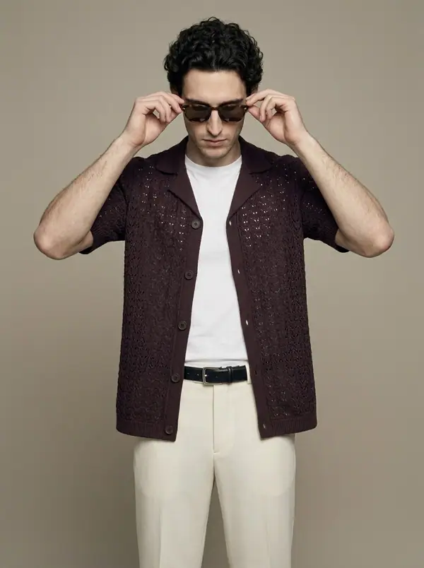 plum crochet pointelle camp-collar knit shirt worn by an AI male model, studio shoot