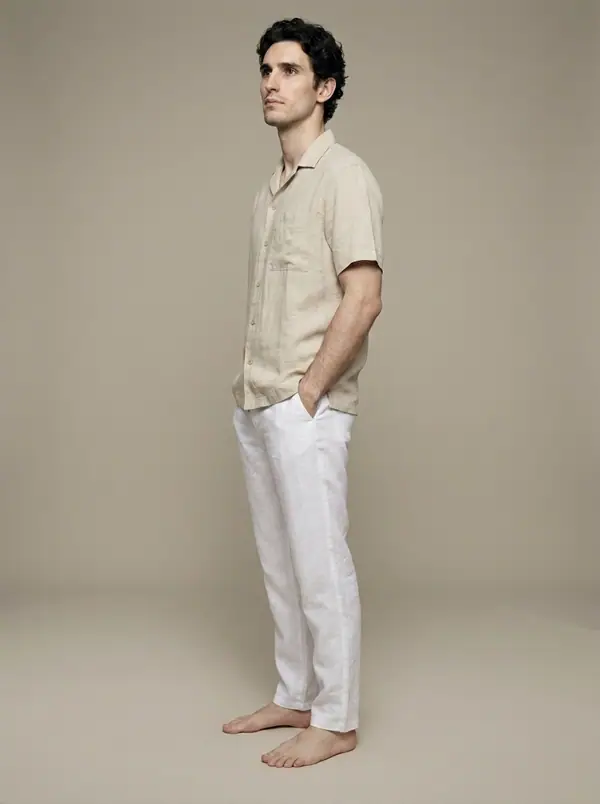 white linen drawstring trousers worn by an AI male model, studio shoot