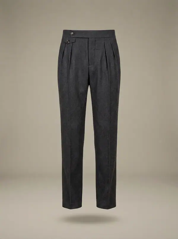 charcoal flannel double-pleat side-tab trousers, photographed as a product shot on a studio sweep